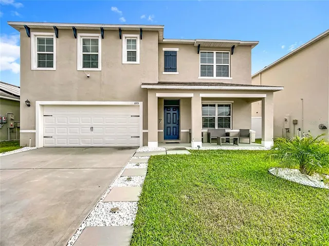 a front view of a house with a yard and porch