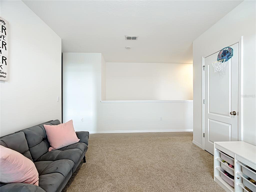 605 Honey Bell Road Winter Haven, FL 33880 - Photo 46 of 71 a living room with a couch and a walk in closet