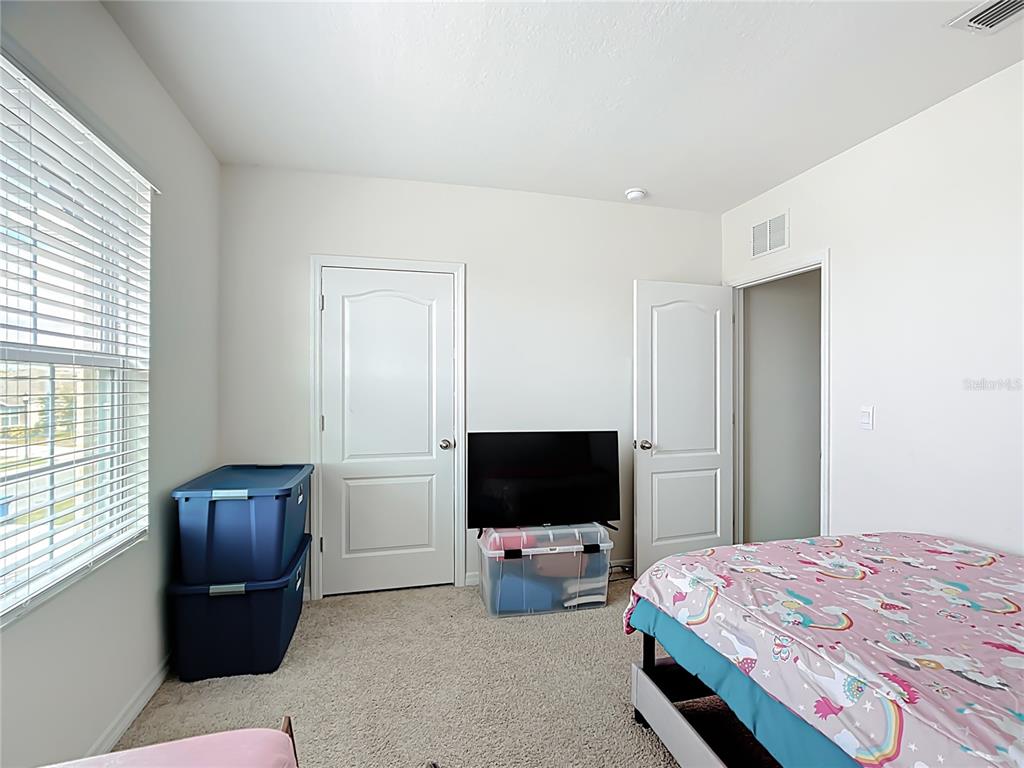 605 Honey Bell Road Winter Haven, FL 33880 - Photo 49 of 71 a bedroom with a bed and flat screen tv