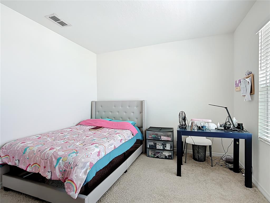 605 Honey Bell Road Winter Haven, FL 33880 - Photo 50 of 73 a bedroom with a bed and a desk