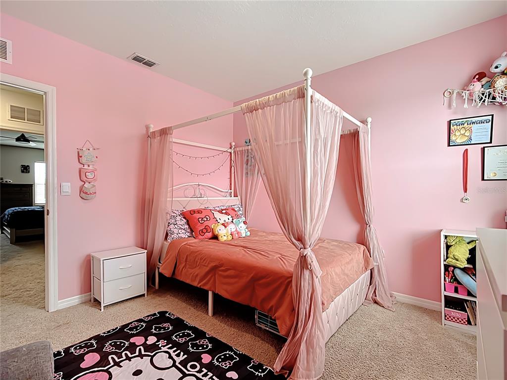 605 Honey Bell Road Winter Haven, FL 33880 - Photo 51 of 71 a bedroom with a bed and a chair