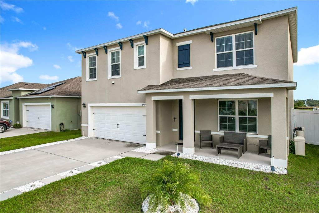 605 Honey Bell Road Winter Haven, FL 33880 - Photo 6 of 71 a front view of a house with a yard and porch