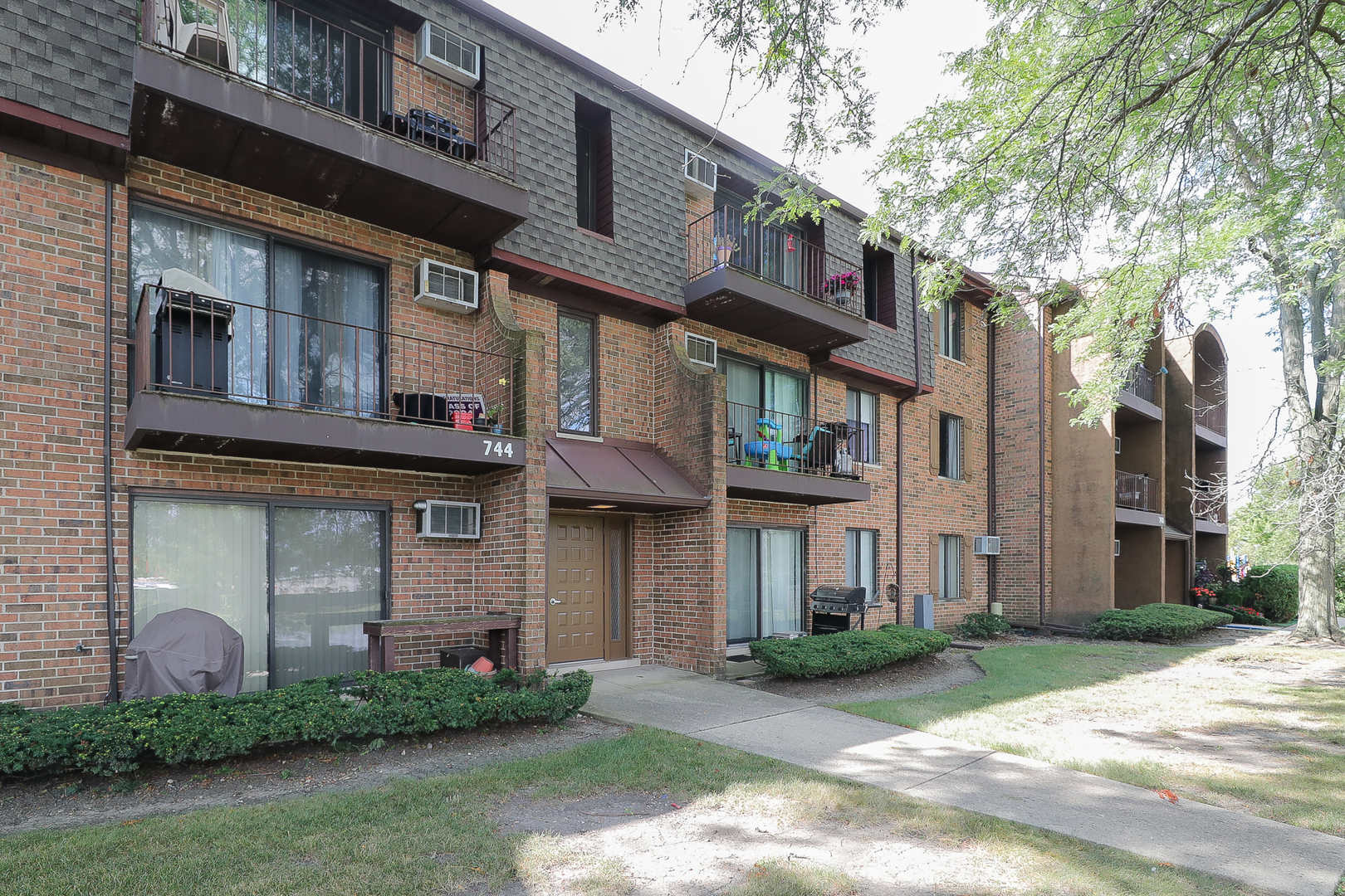 744 Briar Hill Lane, Unit 5 Addison, IL 60101 - Photo 1 of 20 a front view of a building with brick walls