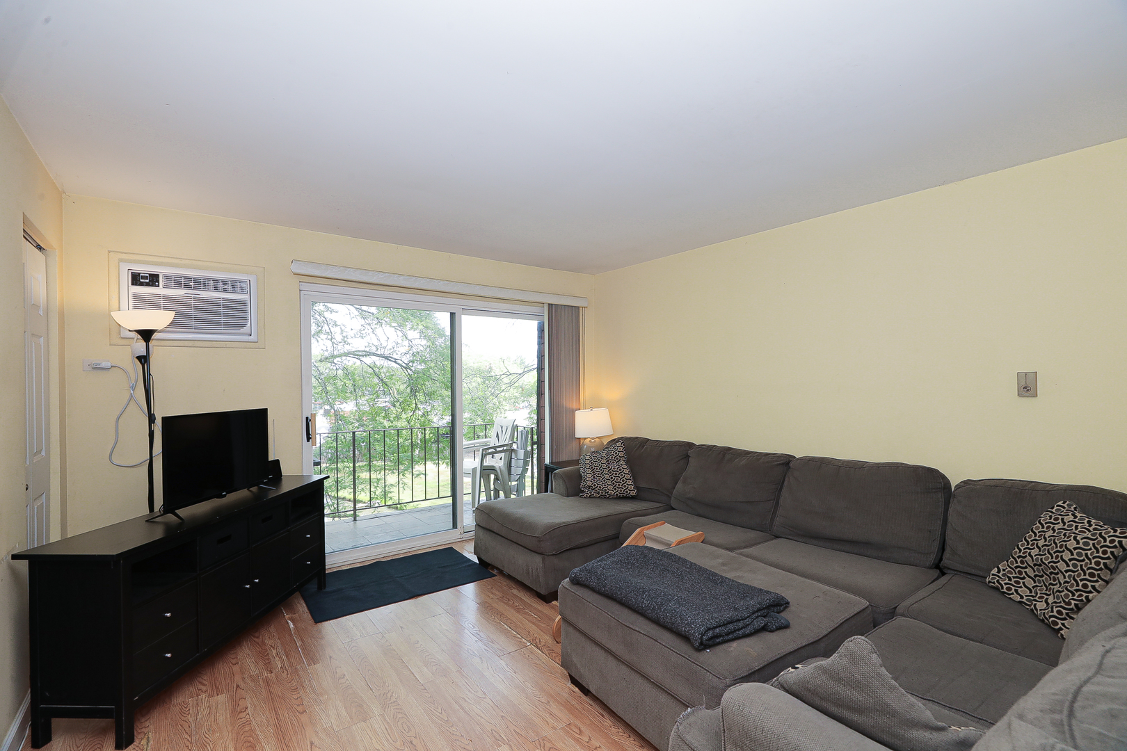 744 Briar Hill Lane, Unit 5 Addison, IL 60101 - Photo 3 of 20 a living room with furniture a flat screen tv and a fireplace