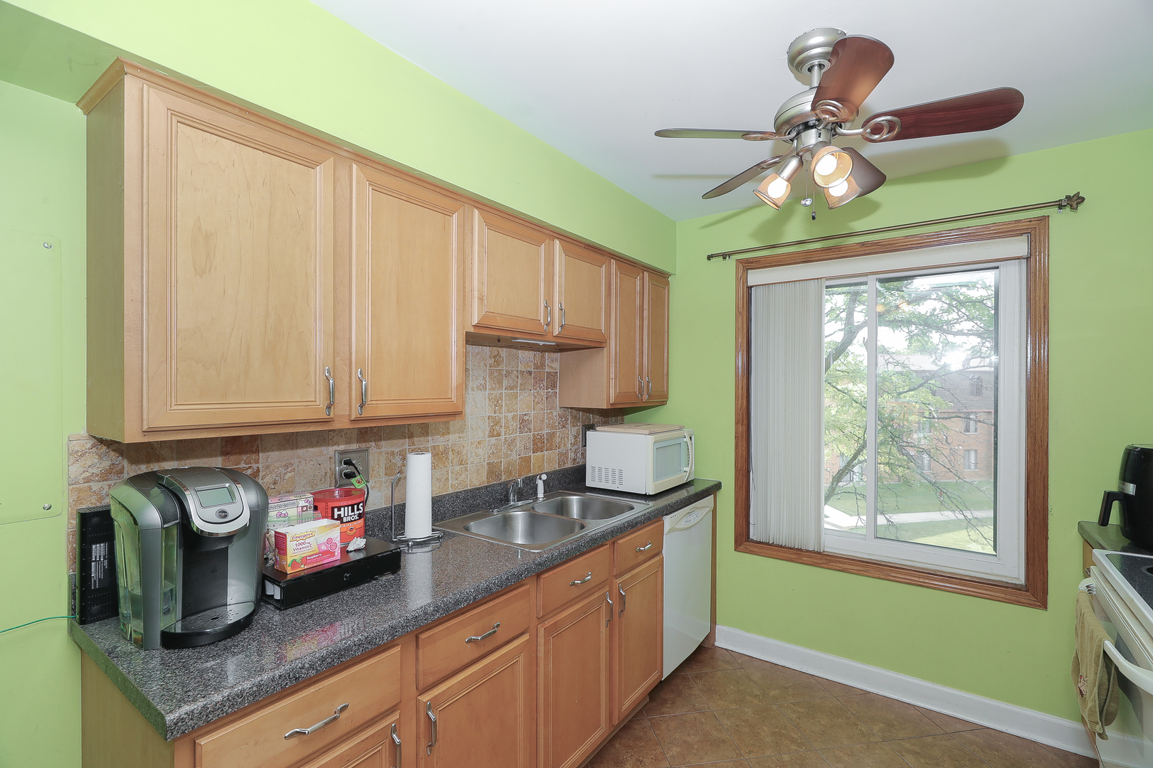 744 Briar Hill Lane, Unit 5 Addison, IL 60101 - Photo 6 of 20 a kitchen with stainless steel appliances granite countertop a sink a refrigerator and cabinets