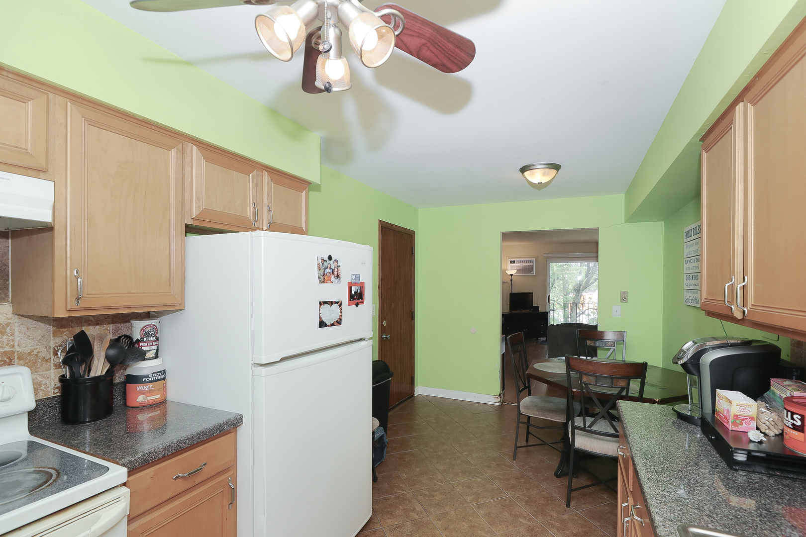 744 Briar Hill Lane, Unit 5 Addison, IL 60101 - Photo 7 of 20 a white refrigerator freezer sitting inside of a kitchen