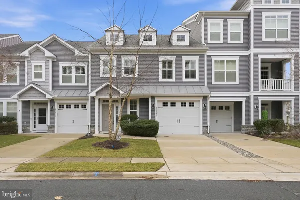 a front view of a residential apartment building with a yard