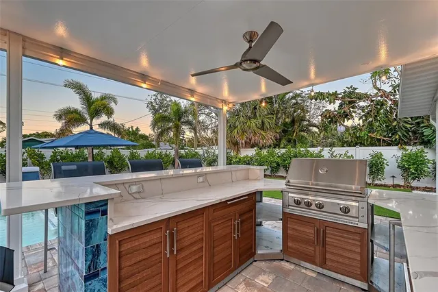 a kitchen with a sink stainless steel appliances a counter space and a window