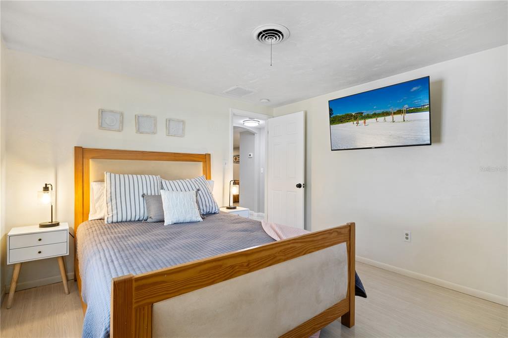 2365 Bay Street Sarasota, FL 34237 - Photo 29 of 93 a bedroom with a large bed and a chandelier