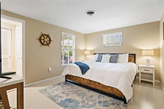 a view of a swimming pool with a table and chairs under an umbrella