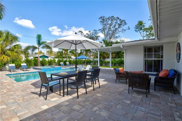 a view of a patio with a table and chairs