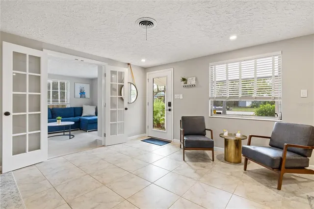 a kitchen with a stove a sink and a potted plant