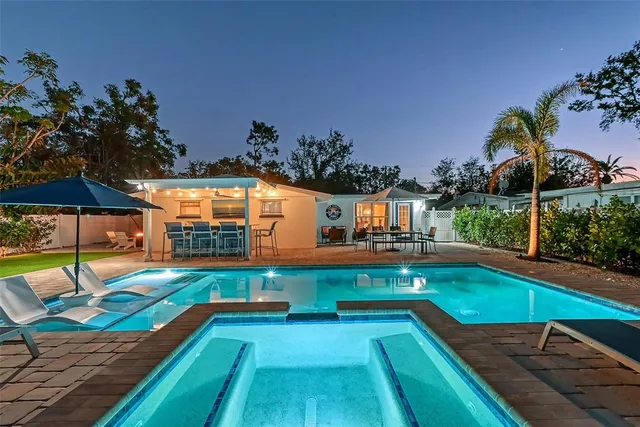 a view of a swimming pool with a table and chairs