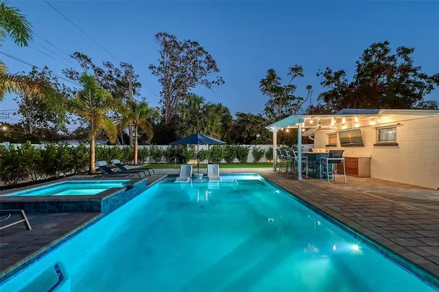 a view of a house with a backyard porch and sitting area