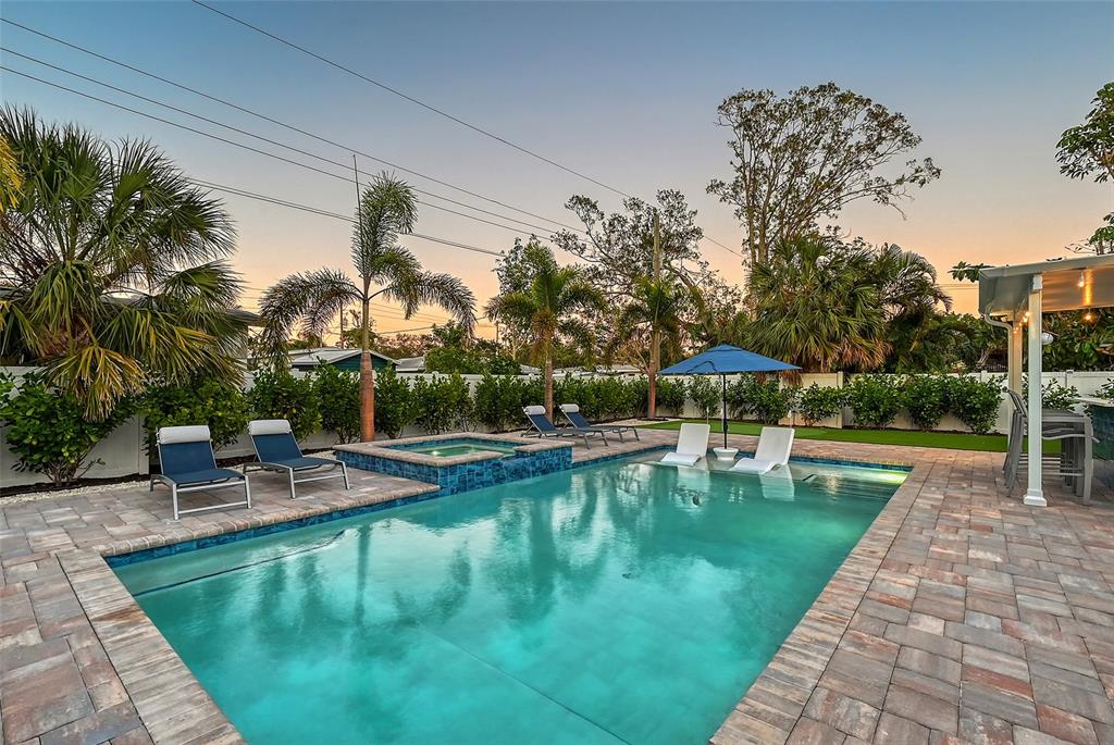 2365 Bay Street Sarasota, FL 34237 - Photo 58 of 93 a view of a swimming pool with a table and chairs