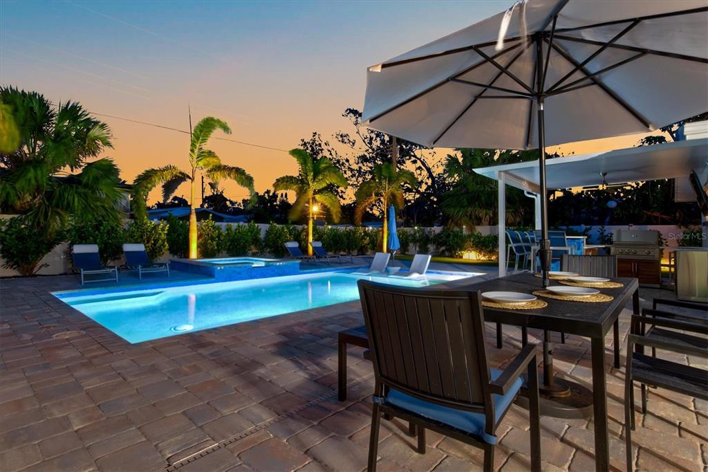 2365 Bay Street Sarasota, FL 34237 - Photo 79 of 93 a view of a swimming pool with a table and chairs