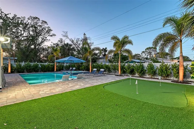 a kitchen with stainless steel appliances refrigerator dining table and chairs