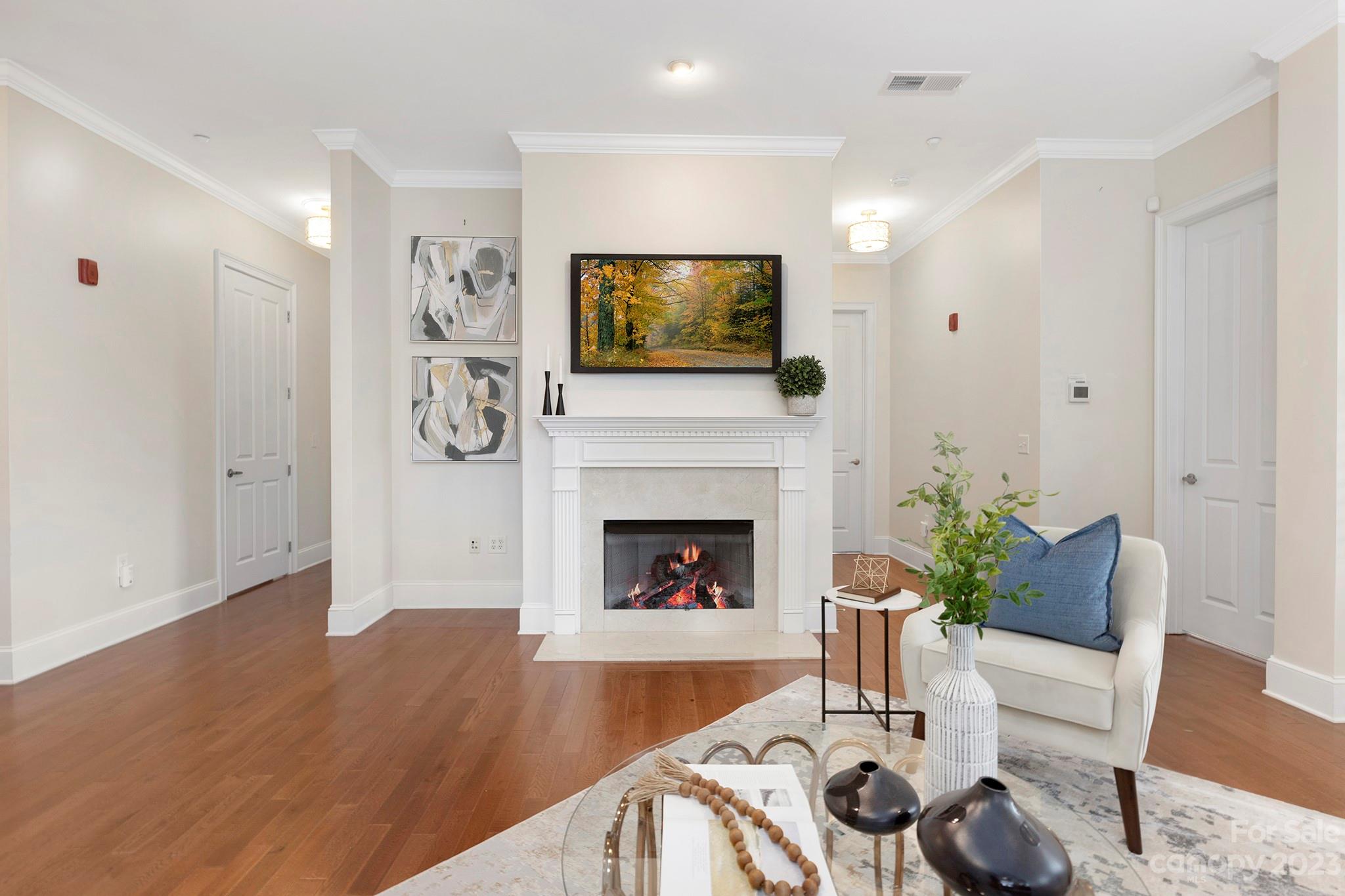 5425 Closeburn Road Charlotte, NC 28210 - Photo 2 of 21 a living room with furniture a flat screen tv and a fireplace