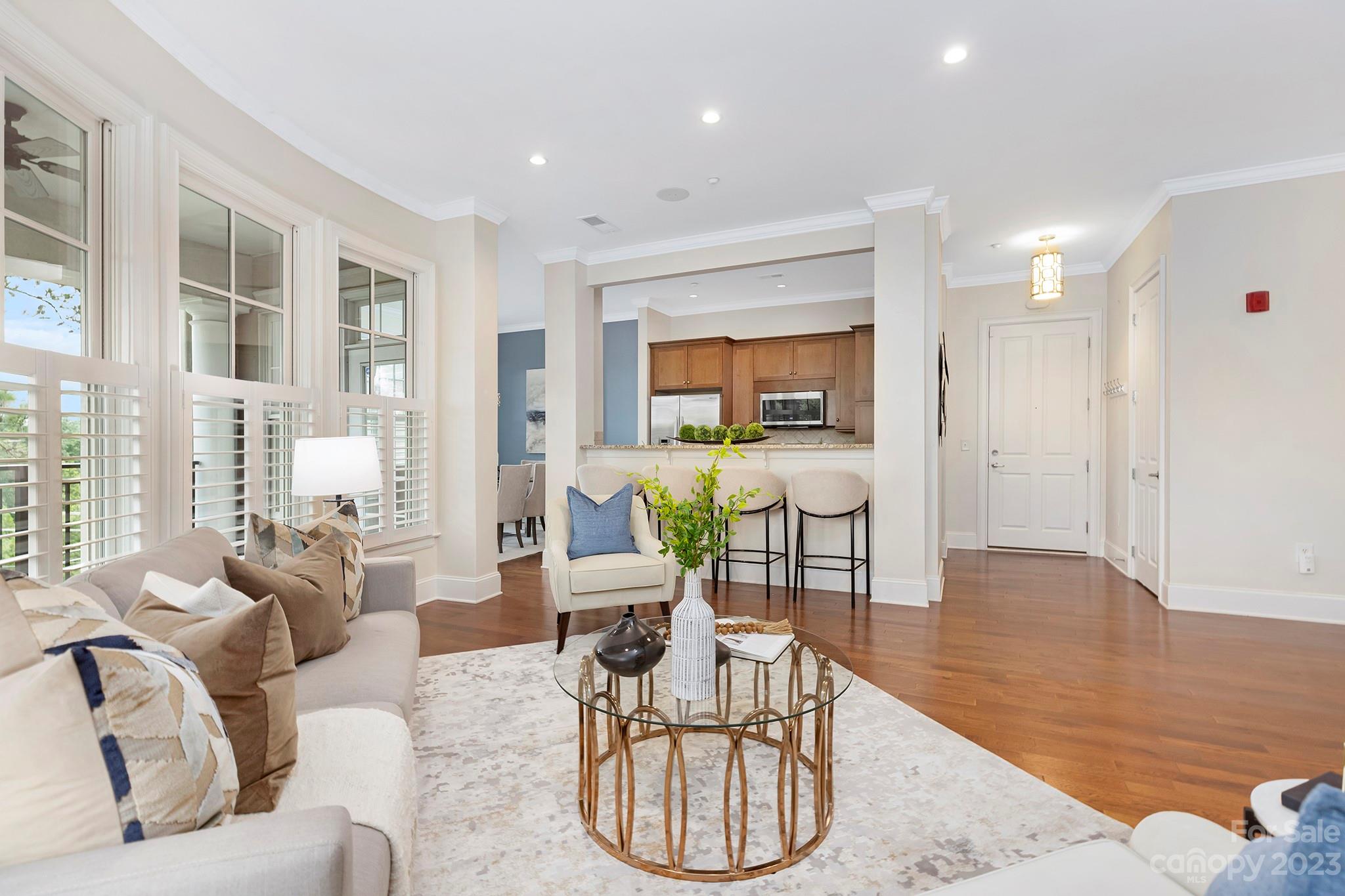 5425 Closeburn Road Charlotte, NC 28210 - Photo 3 of 21 a living room with furniture a dining table and wooden floor
