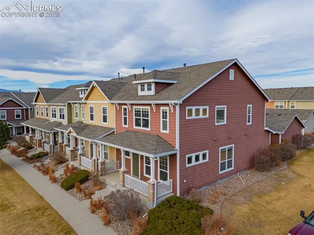 a aerial view of a brick house next to a yard