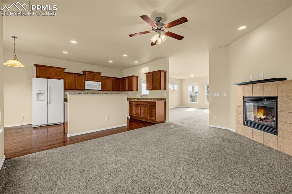 3597 Grey Owl Point Colorado Springs, CO 80916 - Photo 13 of 42 a view of a kitchen with a sink and a fireplace