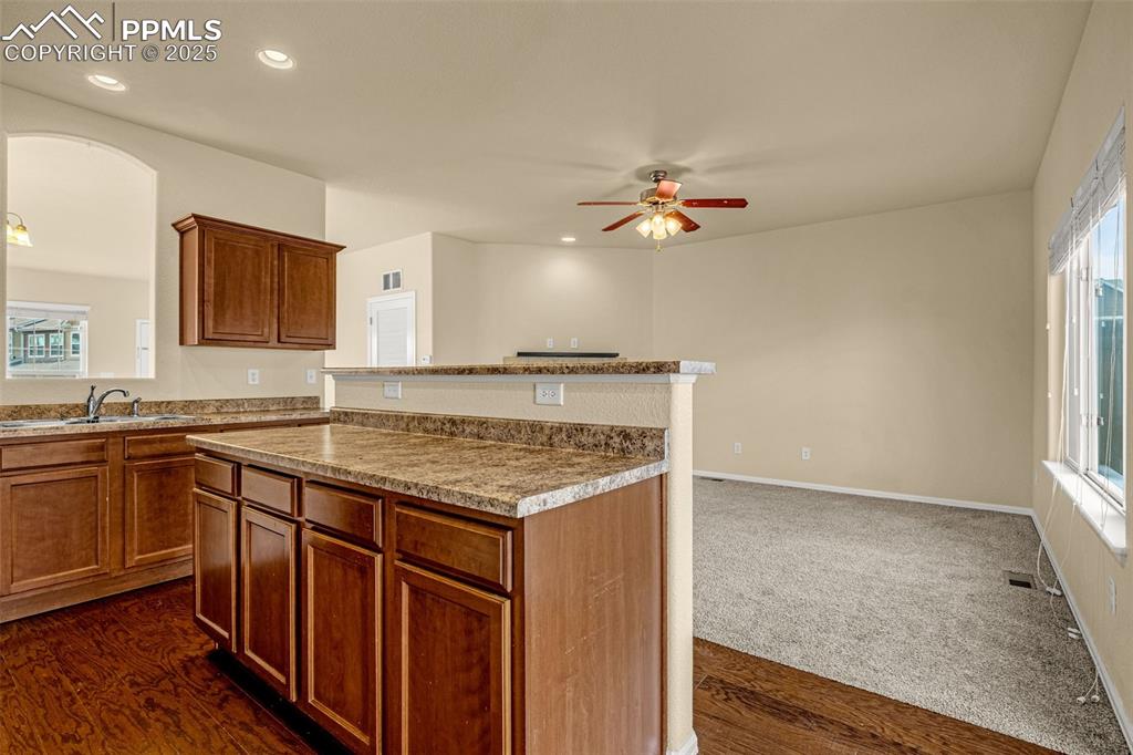 3597 Grey Owl Point Colorado Springs, CO 80916 - Photo 17 of 42 a kitchen with a stove a sink and a refrigerator