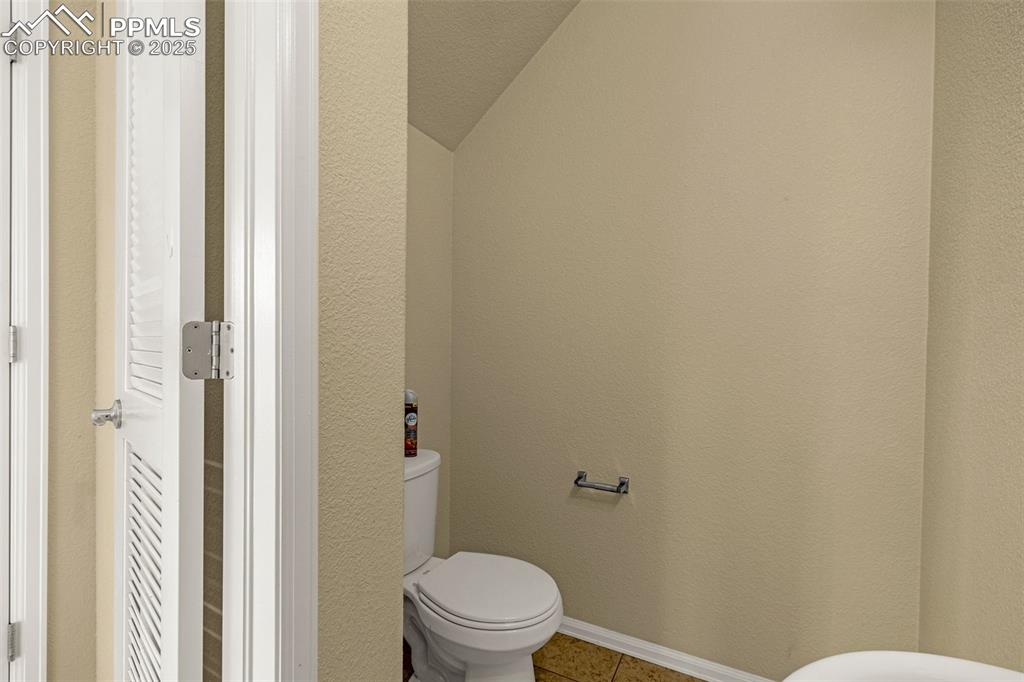 3597 Grey Owl Point Colorado Springs, CO 80916 - Photo 20 of 42 a white toilet sitting next to a shower curtain