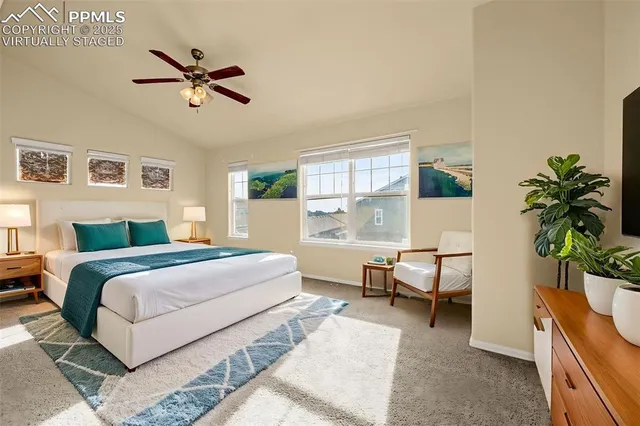 a bedroom with a bed and a potted plant