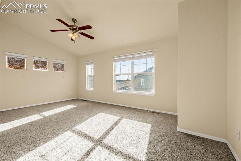 3597 Grey Owl Point Colorado Springs, CO 80916 - Photo 22 of 42 a view of a big room with wooden floor and windows