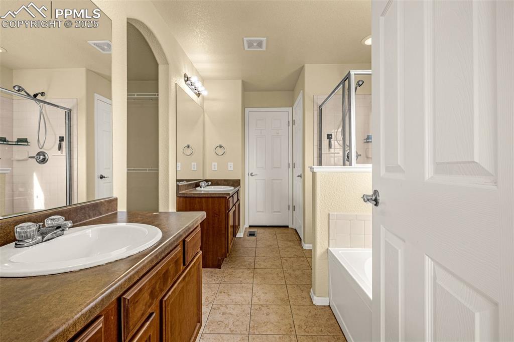 3597 Grey Owl Point Colorado Springs, CO 80916 - Photo 26 of 42 a bathroom with a sink double vanity and a mirror