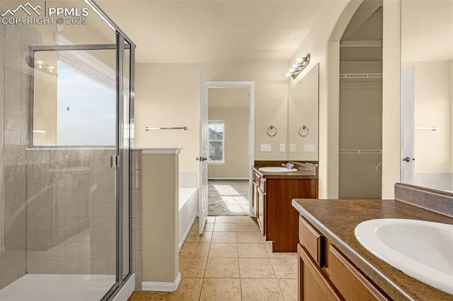 a bathroom with a granite countertop sink a mirror and a shower
