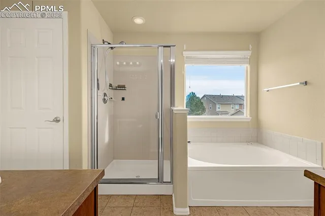 a bathroom with a granite countertop tub shower and sink