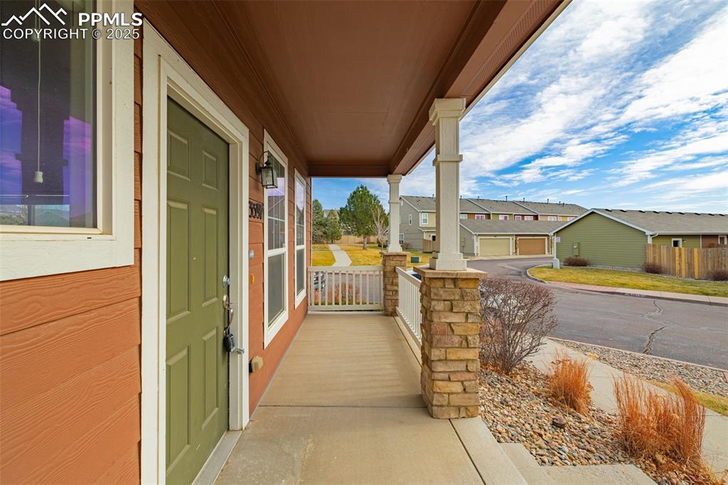3597 Grey Owl Point Colorado Springs, CO 80916 - Photo 4 of 42 a view of a balcony with wooden floor and door