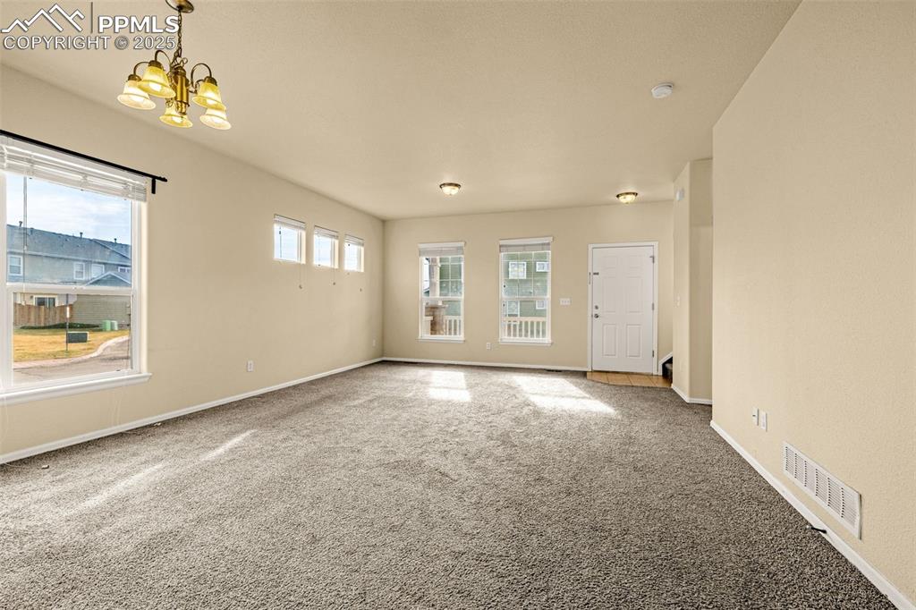 3597 Grey Owl Point Colorado Springs, CO 80916 - Photo 6 of 42 an empty room with a empty space and windows