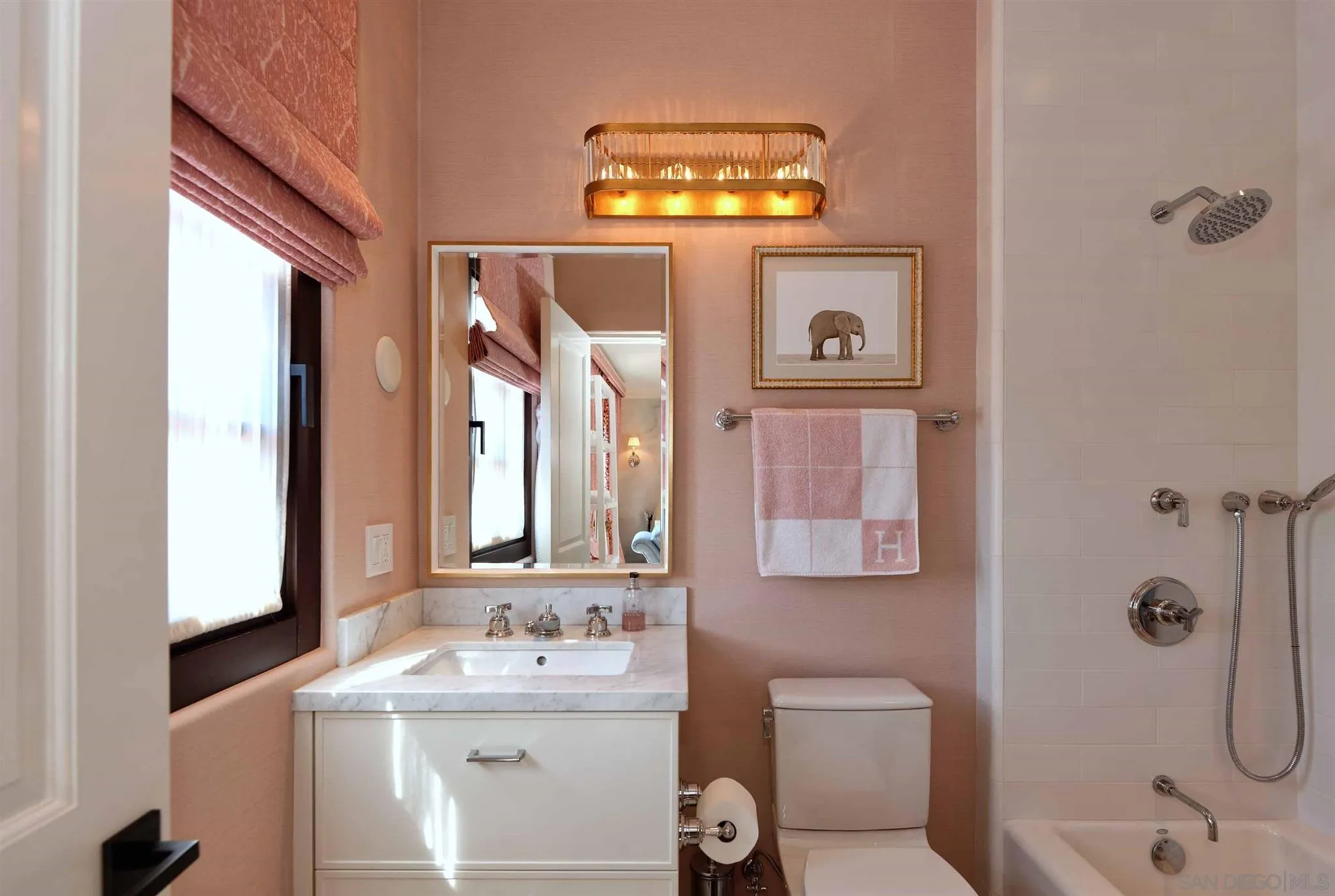 7907 Princess Street La Jolla, CA 92037 - Photo 36 of 41 a bathroom with a sink a mirror a vanity and a shower