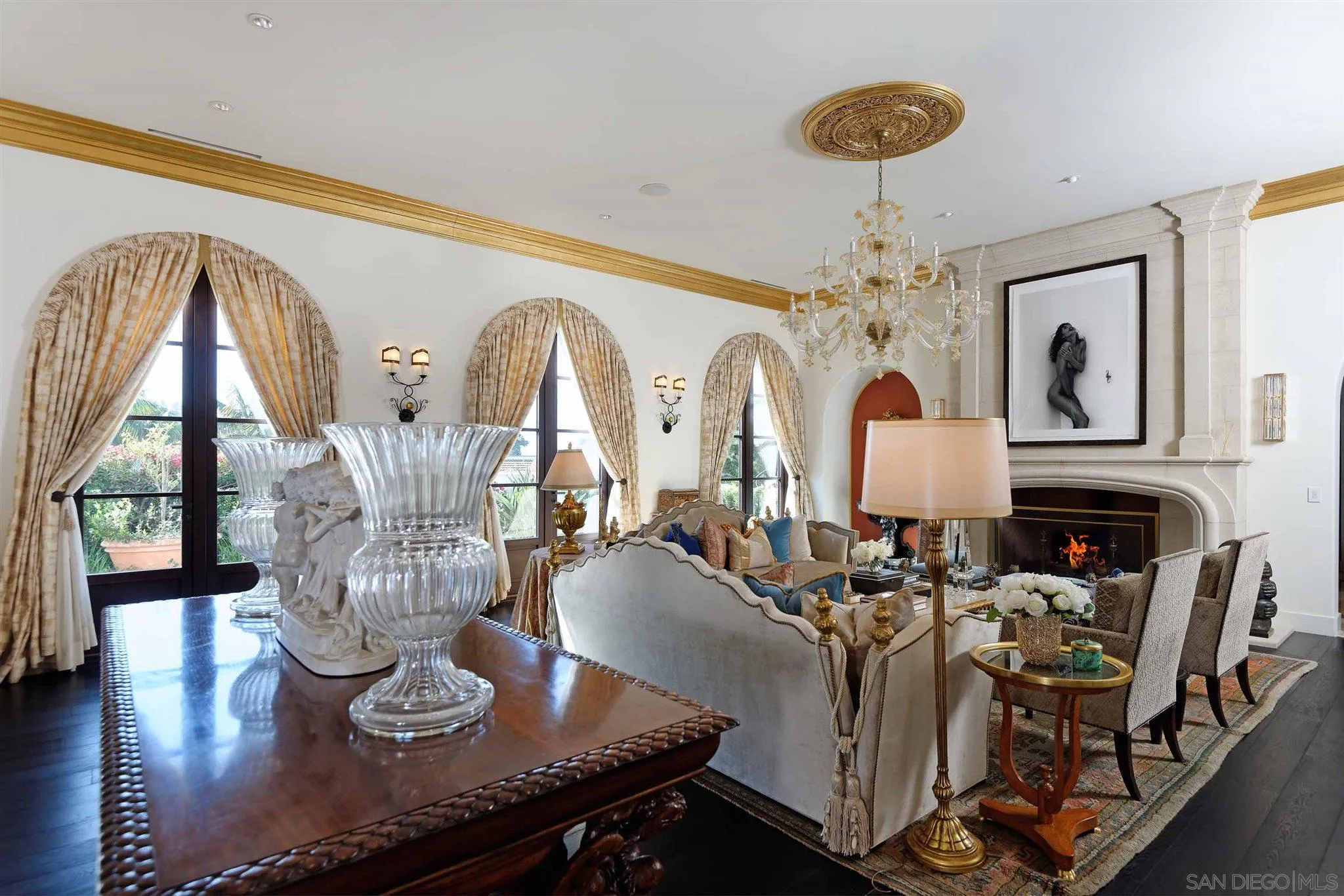 7907 Princess Street La Jolla, CA 92037 - Photo 7 of 41 a living room with furniture a chandelier and a fireplace