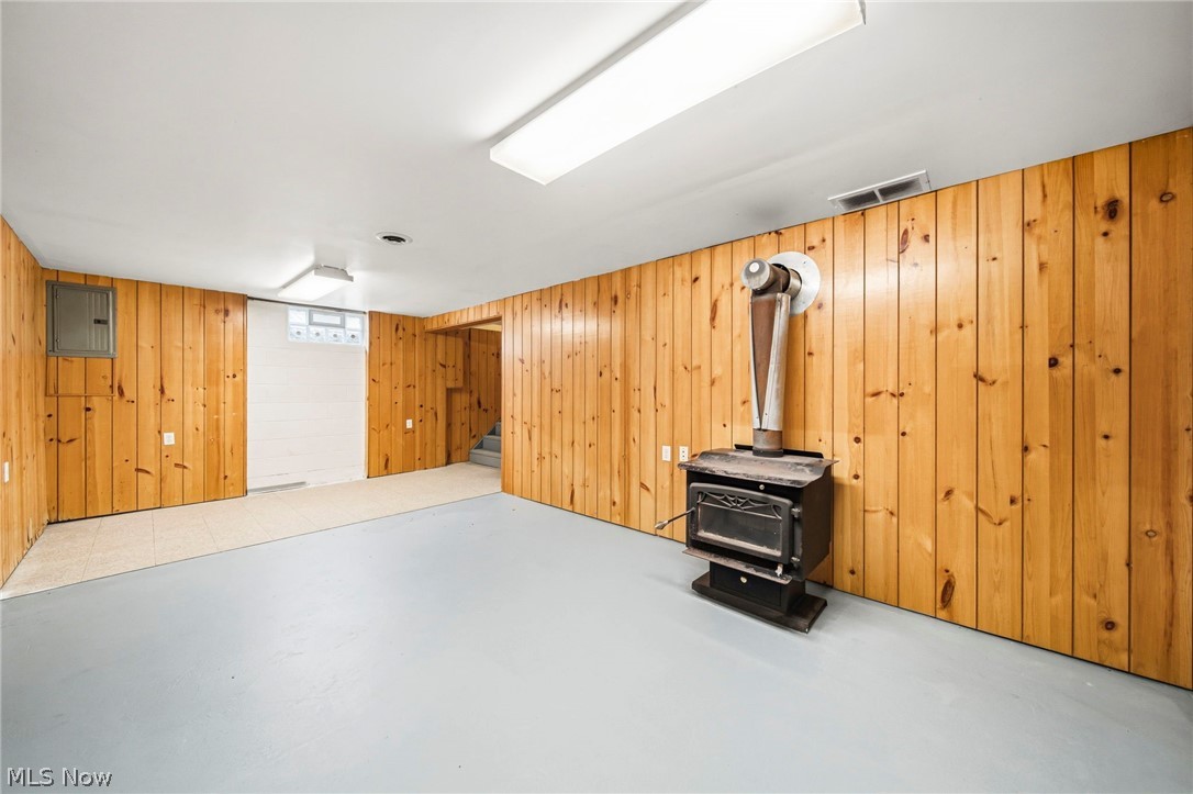 2535 Sears Road Stow, OH 44224 - Photo 29 of 34 Recreation room in the basement with recently painted floors. Seller has never used wood burner, so buyer to do their own due diligence.