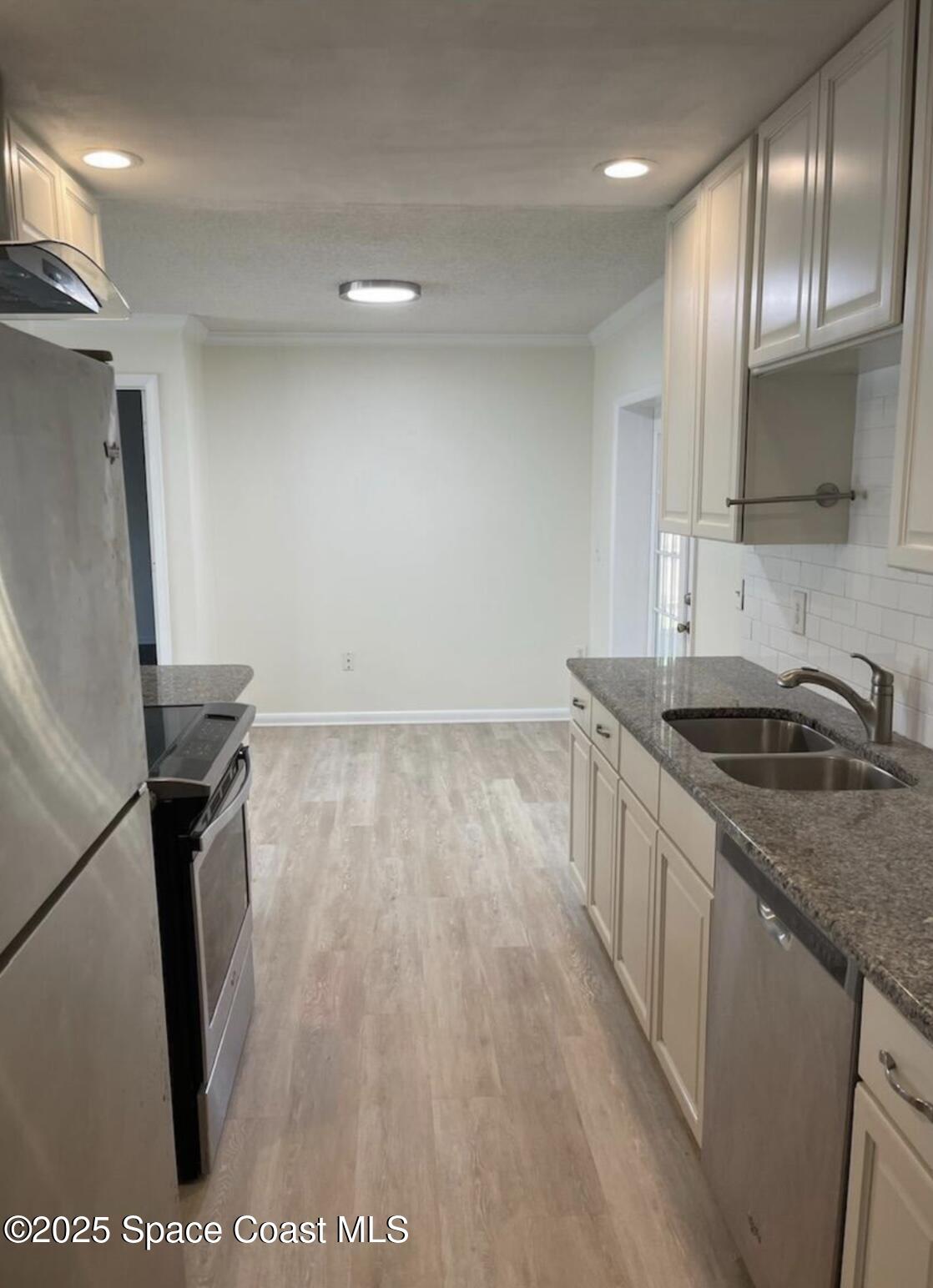 753 Tupelo Drive Melbourne, FL 32935 - Photo 4 of 12 a kitchen with granite countertop a sink appliances and cabinets