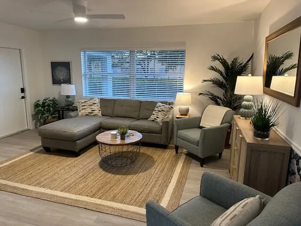 a living room with furniture and a large window