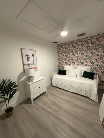 a living room with furniture and a potted plant