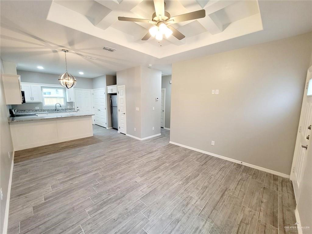 1805 Davenport Street, Unit 1 Weslaco, TX 78596 - Photo 11 of 20 a view of a kitchen with a sink dishwasher a refrigerator with wooden floor