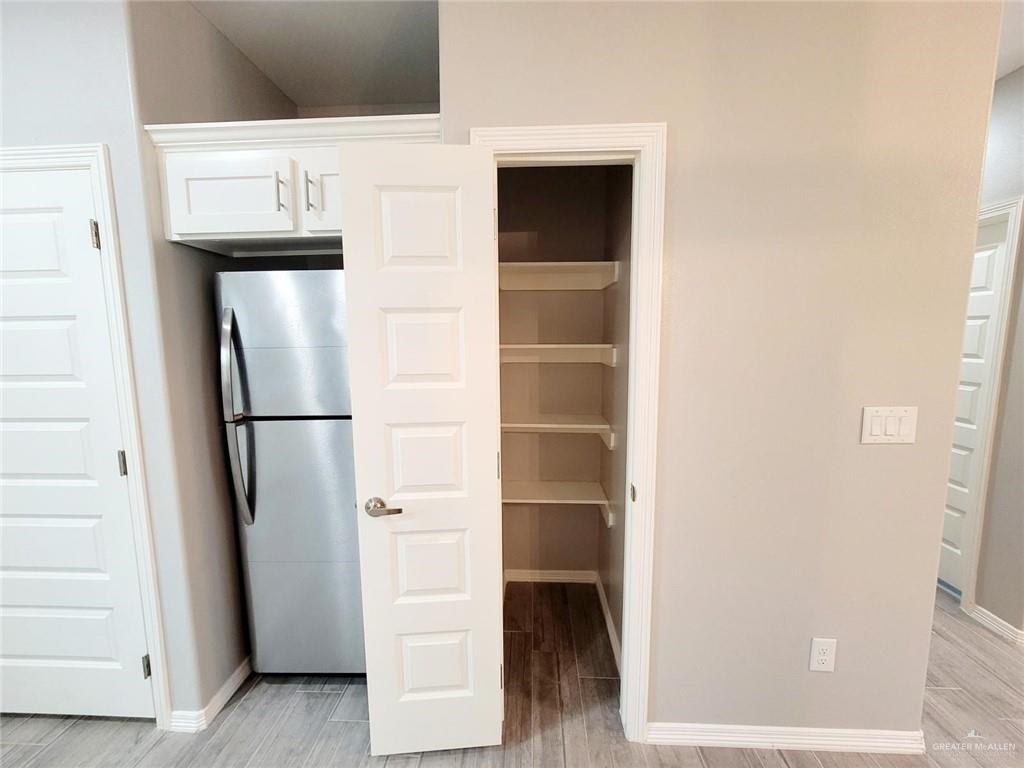1805 Davenport Street, Unit 1 Weslaco, TX 78596 - Photo 13 of 20 a view of walk in closet with empty racks
