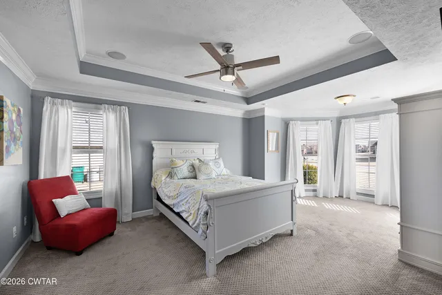 a bedroom with furniture and a large window