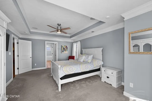 a bed room with a bed and a ceiling fan
