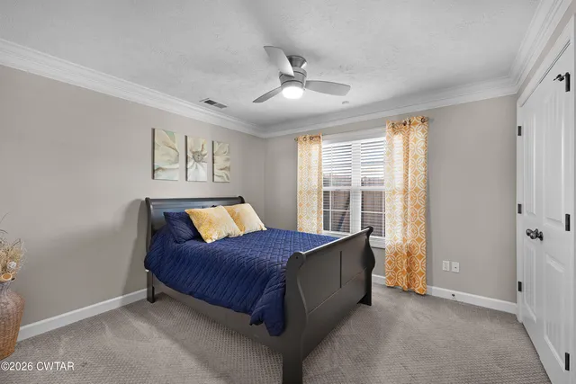 a living room with a bed and a window