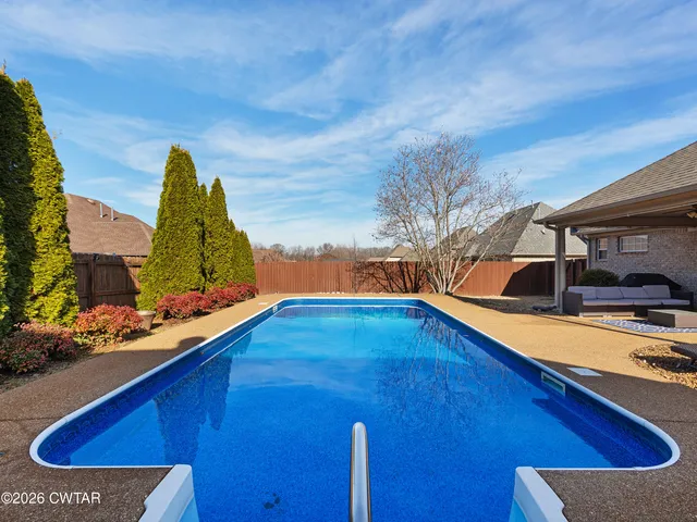 a view of a swimming pool with lounge chair