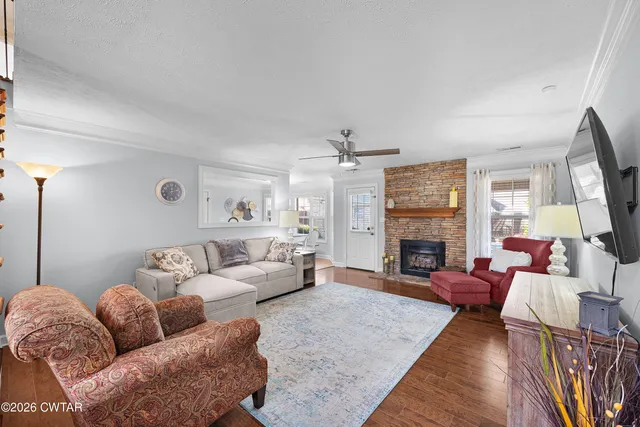 a living room with furniture a fireplace and a flat screen tv