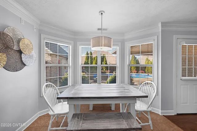 a dining room with furniture a chandelier and wooden floor