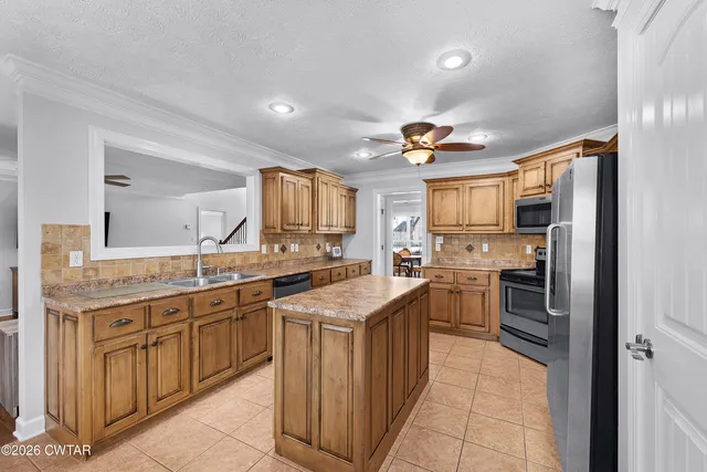a kitchen with a sink counter top space appliances and cabinets