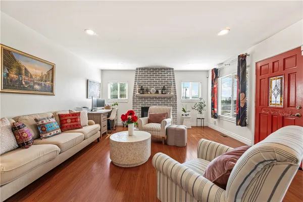 a living room with furniture kitchen view and a fireplace